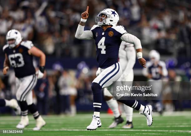 Dak Prescott of the Dallas Cowboys celebrates after a touchdown during an NFL football game against the Washington Commanders at AT&T Stadium on...