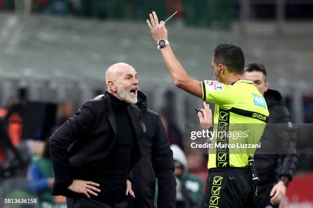 Referee, Marco Di Bello shows a yellow card to Stefano Pioli, Head Coach of AC Milan, during the Serie A TIM match between AC Milan and ACF...