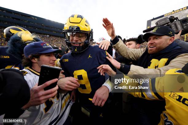 McCarthy of the Michigan Wolverines celebrates with fans on the field after defeating the Ohio State Buckeyes in the game at Michigan Stadium on...