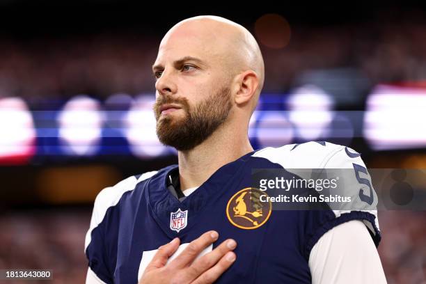 Bryan Anger of the Dallas Cowboys stands on the sidelines during the national anthem prior to an NFL football game against the Washington Commanders...
