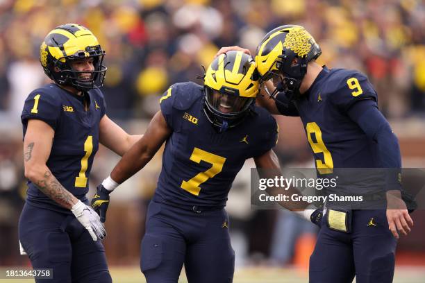 Donovan Edwards of the Michigan Wolverines celebrates with J.J. McCarthy after a pass to Colston Loveland against the Ohio State Buckeyes during the...