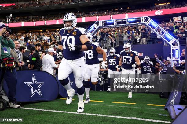 Zack Martin of the Dallas Cowboys runs onto the field prior to an NFL football game against the Washington Commanders at AT&T Stadium on November 23,...