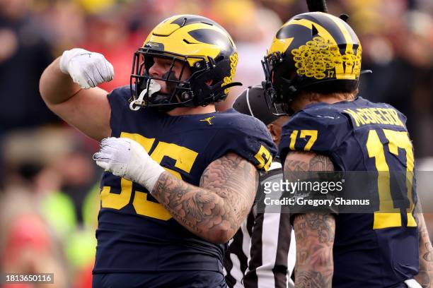 Mason Graham of the Michigan Wolverines celebrates after sacking Kyle McCord of the Ohio State Buckeyes during the second half in the game at...