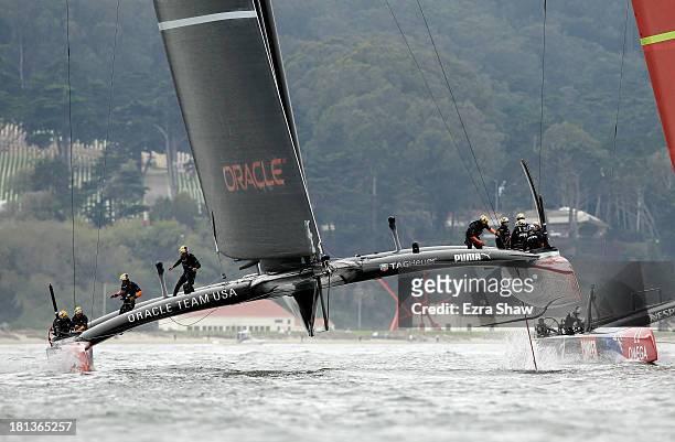 Oracle Team USA skippered by James Spithill races against Emirates Team New Zealand skippered by Dean Barker during race 13 of the America's Cup...