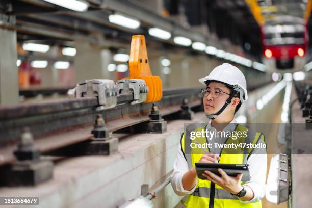 railway engineer checking safety and maintainance in the factory - machinist stockfoto's en -beelden