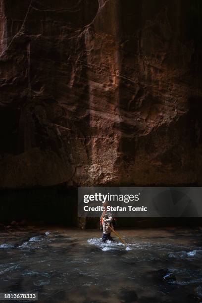 female walking the virgin river in the narrows at zion national park utah - river virgin stock pictures, royalty-free photos & images