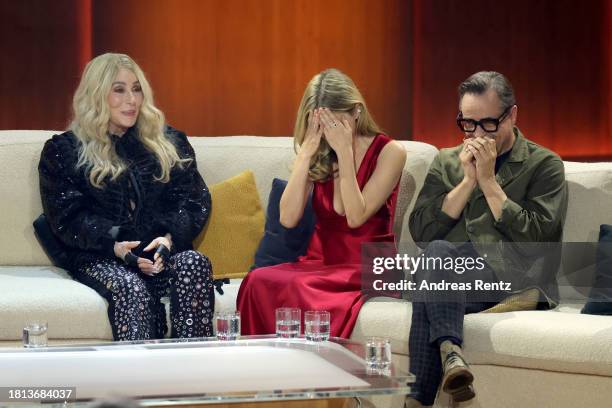 Cher, Stefanie Stappenbeck and Jan Josef Liefers speak on stage during the "Wetten, Dass ...?" tv show on November 25, 2023 in Offenburg, Germany.