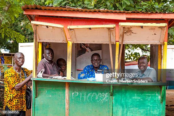 men in booth selling lottery tickets - ghana ashanti stock pictures, royalty-free photos & images