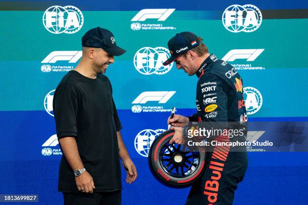 Former football player Sergio Aguero of Argentina and Max Verstappen of the Netherlands and Oracle Red Bull Racing in parc ferme during qualifying...