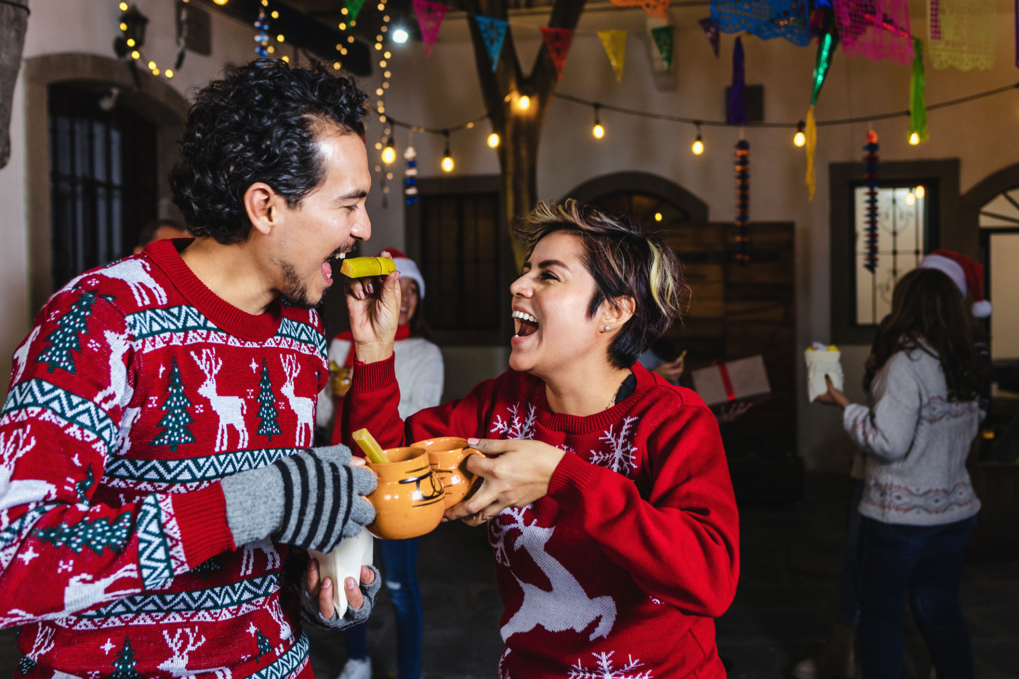 Mexican young couple or friends having fun in posada celebration for Christmas eve in Mexico Latin America, hispanic holidays Mexican young couple or friends having fun in posada celebration for Christmas eve in Mexico Latin America, hispanic holidays