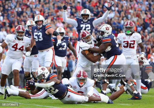 Damari Alston of the Auburn Tigers rushes for a touchdown against Jaylen Key of the Alabama Crimson Tide during the first quarter at Jordan-Hare...