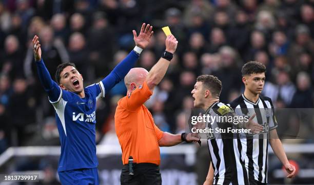 Referee Simon Hooper yellow cards Kieran Trippier of Newcastle as Chelsea player Enzo Fernandez reacts during the Premier League match between...