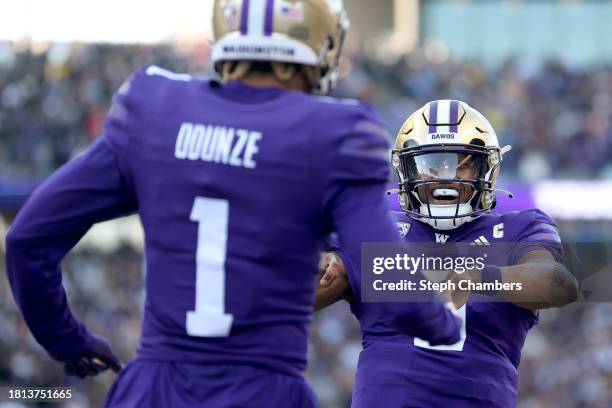 Rome Odunze of the Washington Huskies celebrates his touchdown with Michael Penix Jr. #9 of the Washington Huskies against the Washington State...