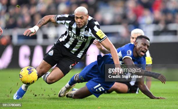 Chelsea player Nicolas Jackson is challenged by Newcastle player Joelinton during the Premier League match between Newcastle United and Chelsea FC at...