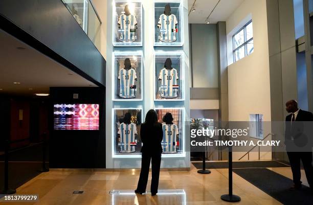 Visitors look at the six 2022 FIFA World Cup match-worn shirts belonging to Inter Miami's Argentine forward Lionel Messi, during a Sotheby's auction...