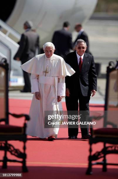 Pope Benedict XVI is welcomed by Cuban President Raul Castro after his arrival at Antonio Macedo airport, in Santiago de Cuba, 915 km southeast of...