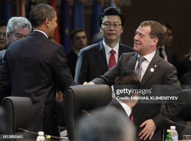 President Barack Obama shakes hands with Russia's President Dmitry Medvedev at the start of the first plenary session of the 2012 Nuclear Security...