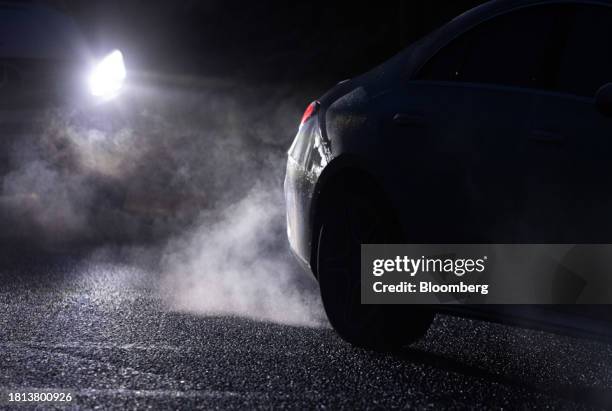 Exhaust fumes illuminated by a cars headlights in Brentwood, UK, on Thursday, Nov. 30, 2023. A levy on drivers of older cars with dirtier engines has...