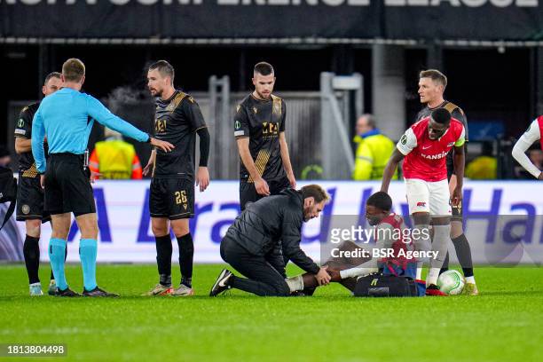 Bruno Martinis Indi of AZ Alkmaar, Riechedly Bazoer of AZ Alkmaar in medical treatment due to injury, Referee Oleksii Derevinskyi in discussion with...