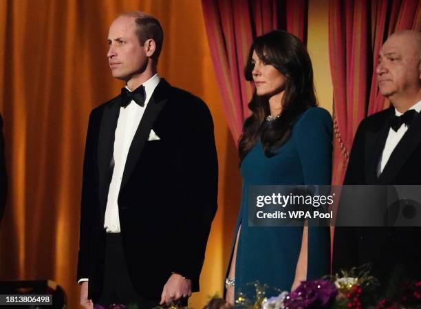 Prince William, Prince of Wales and Catherine, Princess of Wales stand for the national anthem during the Royal Variety Performance before the Royal...