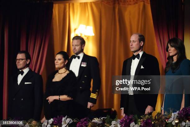 Prince William, Prince of Wales and Catherine, Princess of Wales with Crown Princess Victoria and Prince Daniel of Sweden stand for the national...