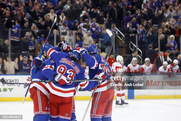 The New York Rangers celebrate after K'Andre Miller score a goal in the 3rd period against the Detroit Red Wings at Madison Square Garden on November...
