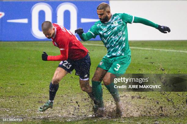 Lille's Kosovar midfielder Edon Zhegrova fighst for the ball with Olimpija's Portuguese defender David Sualehe during the UEFA Europa Conference...