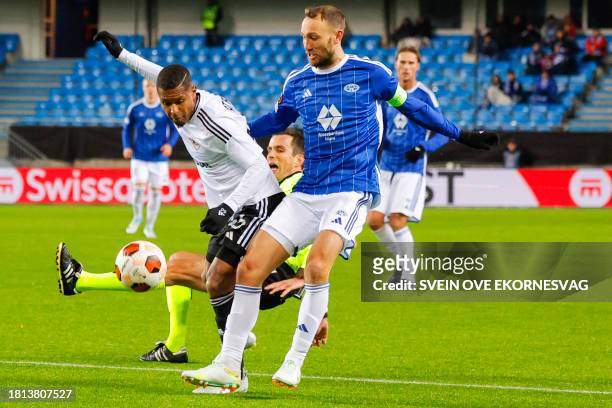 Garabagh's Colombian defender Kevin Medina and Molde's Norwegian midfielder Magnus Eikrem vie for the ball as Belgian referee Erik Lambrechts falls...