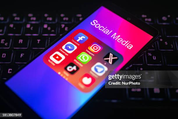 Close-up of the Facebook mobile app is being displayed on a smartphone screen next to those of TikTok, Telegram, Instagram, X, YouTube, and Messenger...