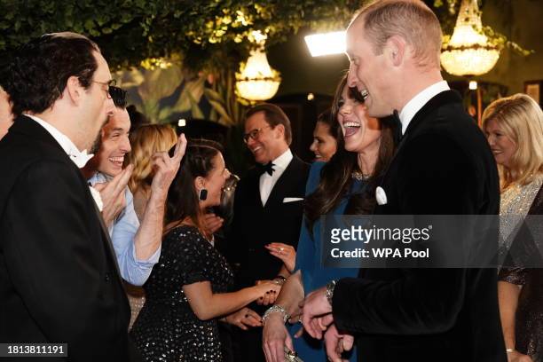 Catherine, Princess of Wales and Prince William, Prince of Wales speak with performers during the Royal Variety Performance at the Royal Albert Hall...