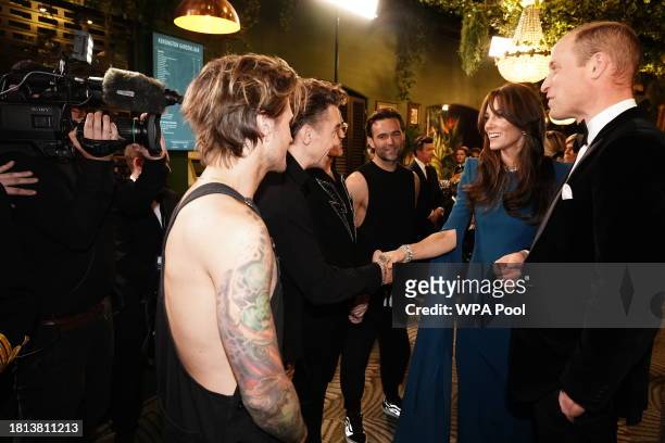 Catherine, Princess of Wales and Prince William, Prince of Wales meet members of McFly during the Royal Variety Performance at the Royal Albert Hall...