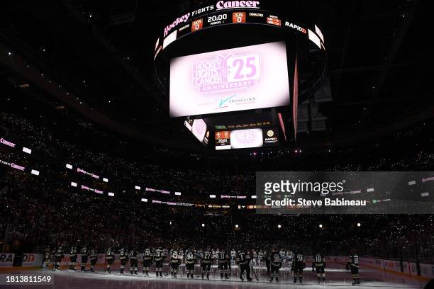 Fans light up their phones honoring 25 years of Hockey Fights Cancer before the game of the Boston Bruins against the San Jose Sharks on November 30,...