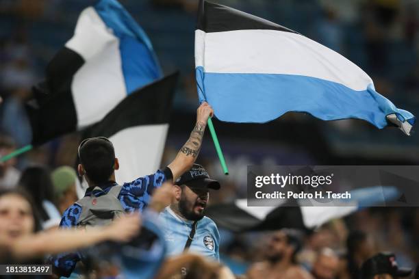 Fans of Gremio cheer for their team during the match between Gremio and Goias as part of Brasileirao 2023 at Arena do Gremio on November 30, 2023 in...