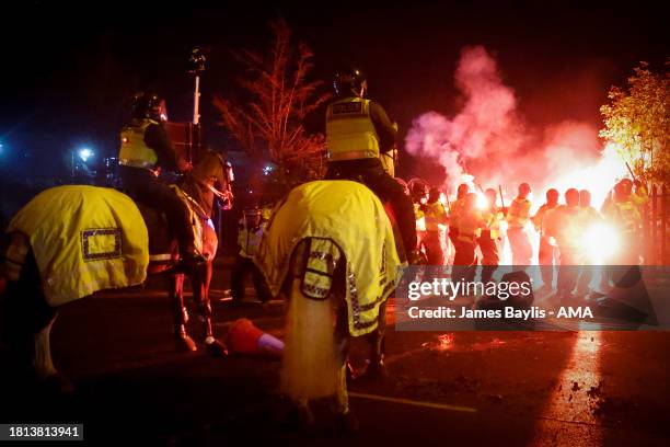 Police clash with Legia Warszawa fans outside the stadium before the UEFA Europa Conference League match between Aston Villa and Legia Warszawa at...