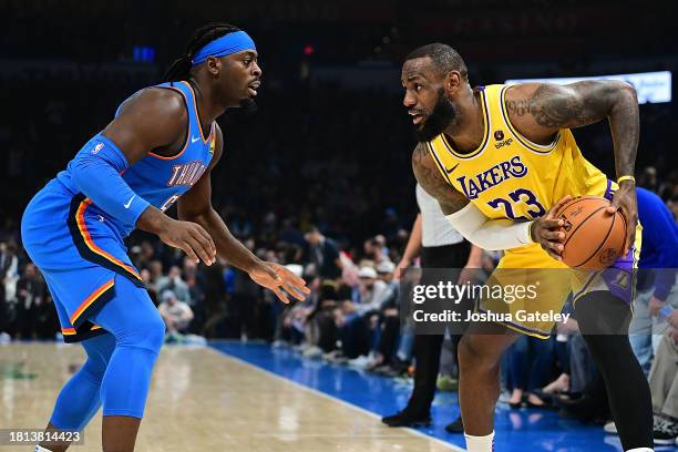 Lebron James of the Los Angeles Lakers handles the ball while being defended by Luguentz Dort of the Oklahoma City Thunder during the first half at...