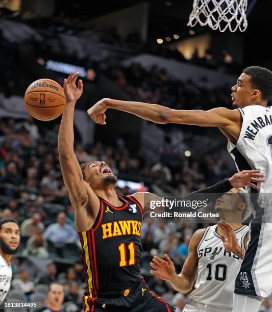 Victor Wembanyama of the San Antonio Spurs blocks shot of Trae Young of the Atlanta Hawks in the first half at Frost Bank Center on November 30, 2023...