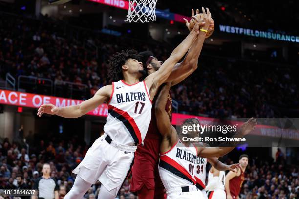 Jarrett Allen of the Cleveland Cavaliers battles Shaedon Sharpe and Scoot Henderson of the Portland Trail Blazers for a rebound during the second...