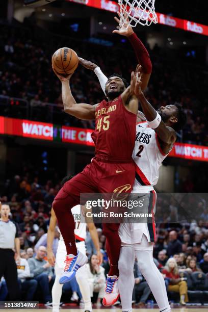 Donovan Mitchell of the Cleveland Cavaliers shoots against Deandre Ayton of the Portland Trail Blazers during the second half at Rocket Mortgage...