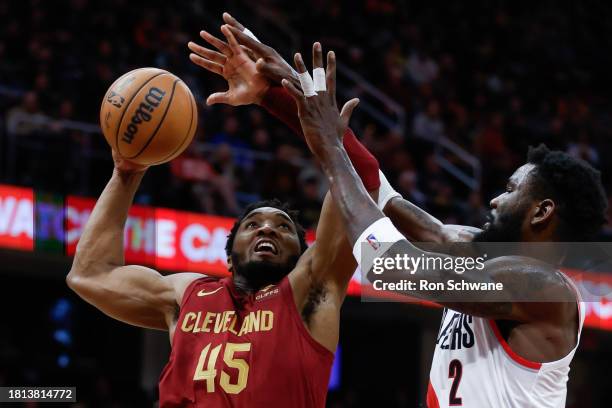 Donovan Mitchell of the Cleveland Cavaliers shoots against Deandre Ayton of the Portland Trail Blazers during the second half at Rocket Mortgage...