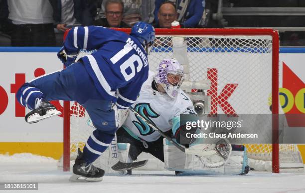 Mitchell Marner of the Toronto Maple Leafs scores the overtime shootout winning goal against Philipp Grubauer of the Seattle Kraken in an NHL game at...