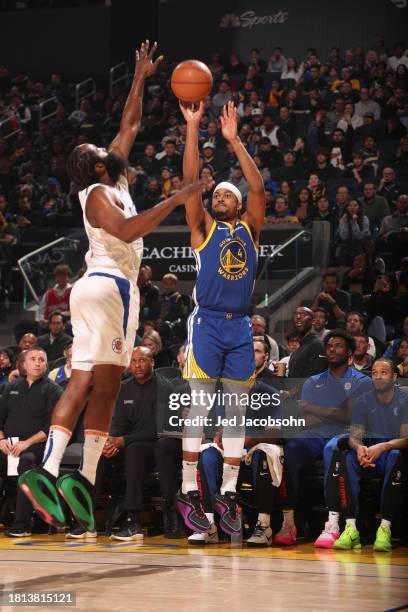 Moses Moody of the Golden State Warriors shoots a three point basket over defender James Harden of the LA Clippers during the game on November 30,...