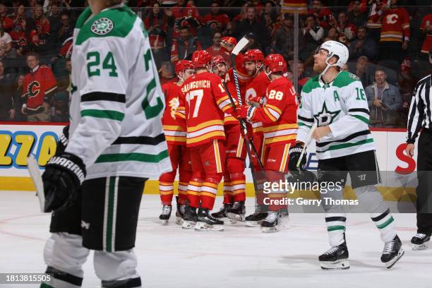 Chris Tanev of the Calgary Flames celebrate a goal against the Dallas Stars with teammates in the first period at Scotiabank Saddledome on November...