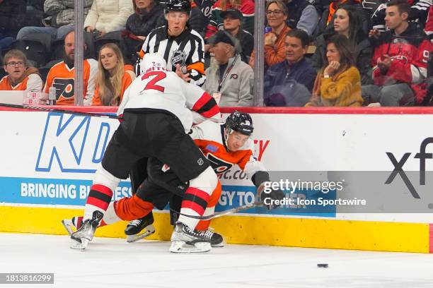 New Jersey Devils Defenseman Brendan Smith checks Philadelphia Flyers Right Wing Bobby Brink into the boards during the second period of the National...