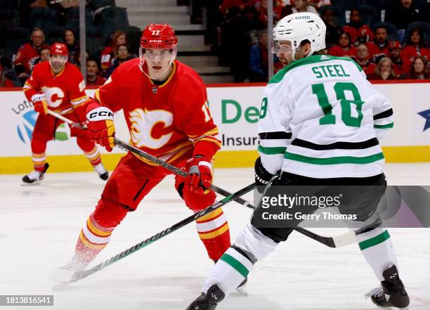 Yegor Sharangovich of the Calgary Flames skates against Sam Steel of the Dallas Stars at Scotiabank Saddledome on November 30, 2023 in Calgary,...