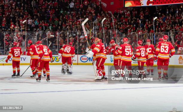 Jacob Markstrom of the Calgary Flames celebrates with teammates after a win against the Dallas Stars at Scotiabank Saddledome on November 30, 2023 in...