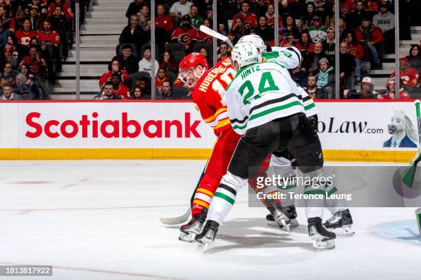 Johnathan Huberdeau of the Calgary Flames skates against Roope Hintz the Dallas Stars at Scotiabank Saddledome on November 30, 2023 in Calgary,...