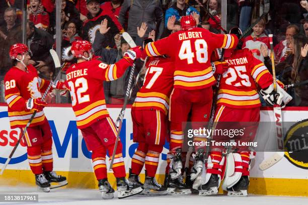 Dennis Gilbert of the Calgary Flames celebrates with teammates after a win against the Dallas Stars at Scotiabank Saddledome on November 30, 2023 in...