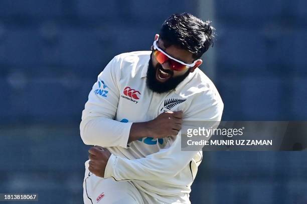 New Zealand's Ajaz Patel celebrates after the dismissal of Bangladesh's Mushfiqur Rahim during the fourth day of the first Test cricket match between...