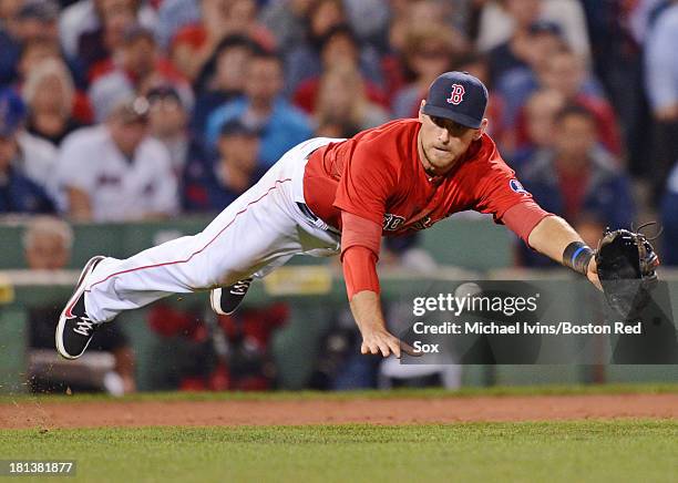 Will Middlebrooks of the Boston Red Sox dives for a ground ball against the Toronto Blue Jays in the fifth inning on September 20, 2013 at Fenway...