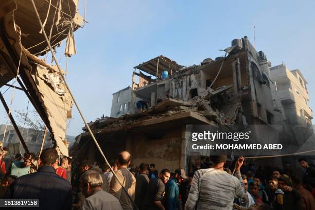 Graphic content / Palestinians check the rubble of a building destroyed in an Israeli air strikes on the Rafah refugee camp in the southern Gaza...